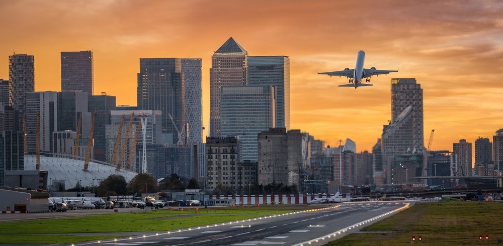 Panoramic view of the London skyline with Canary Wharf district and the runway of the City Airport