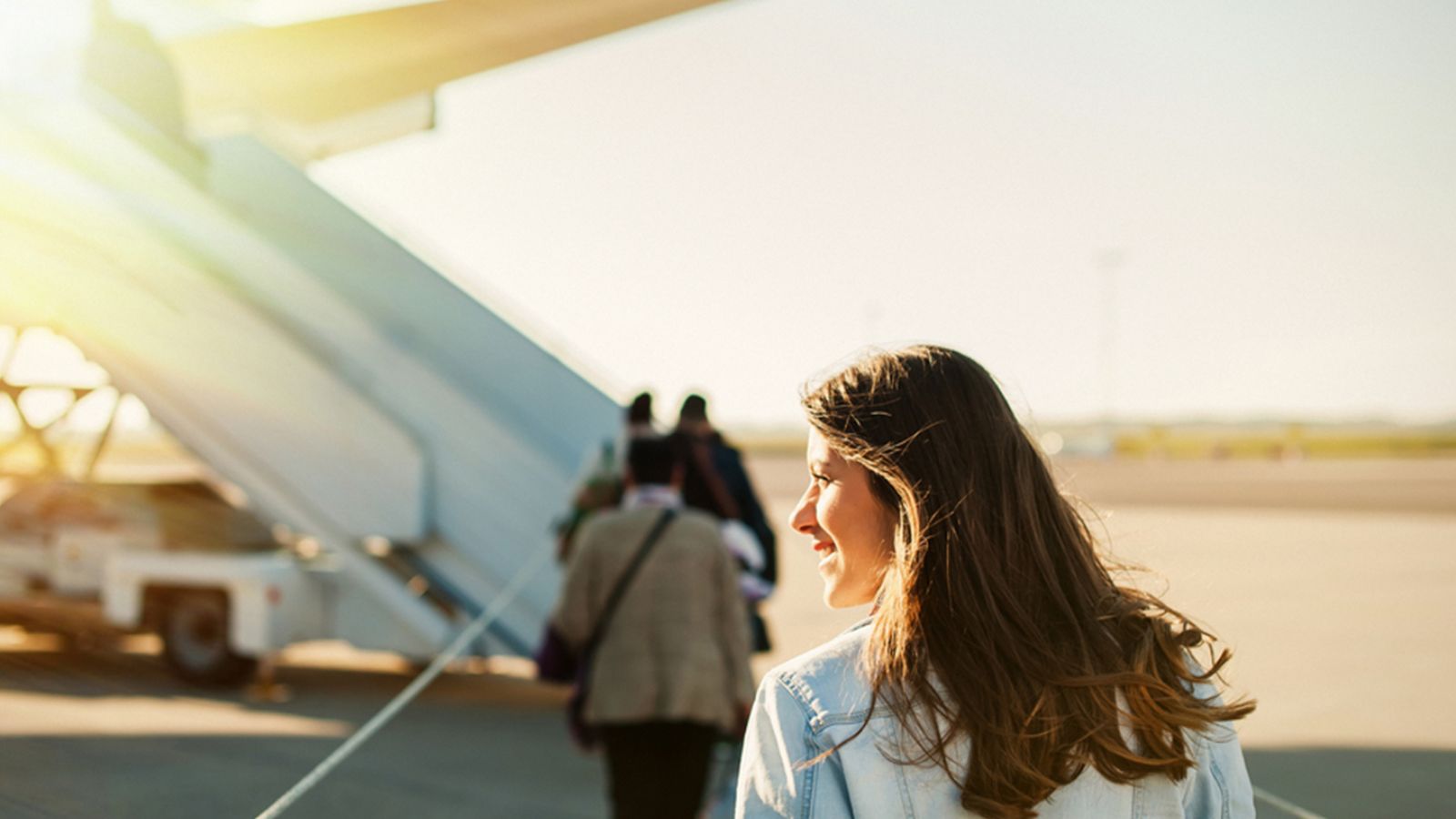 Lady walking over to board group charter aircraft