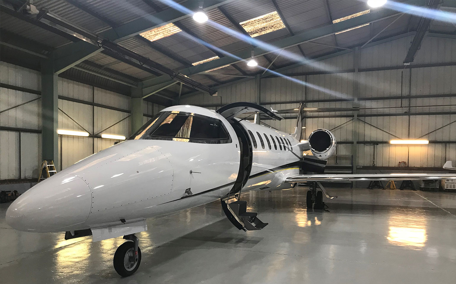 Learjet 45 private jet inside hanger