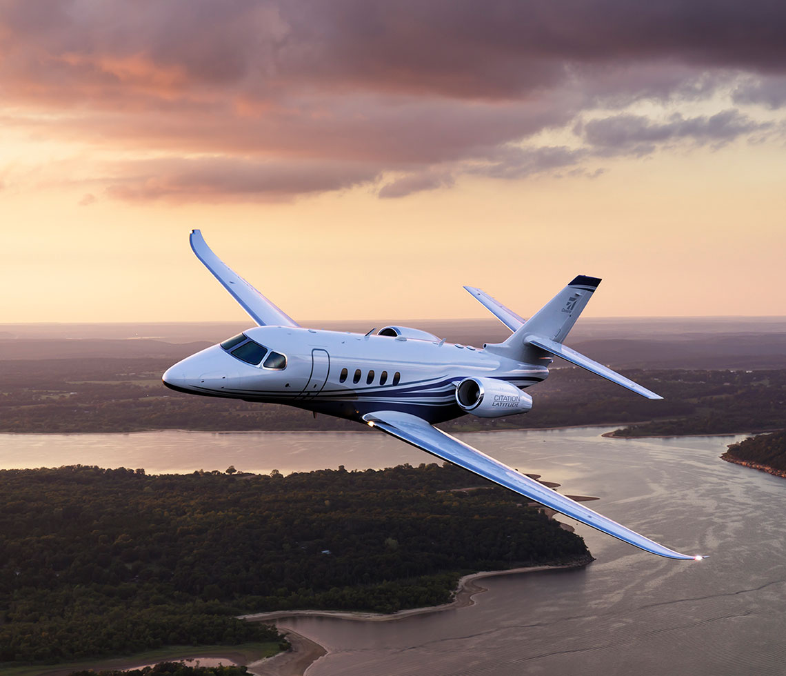 Cessna Citation Latitude private jet flying over river