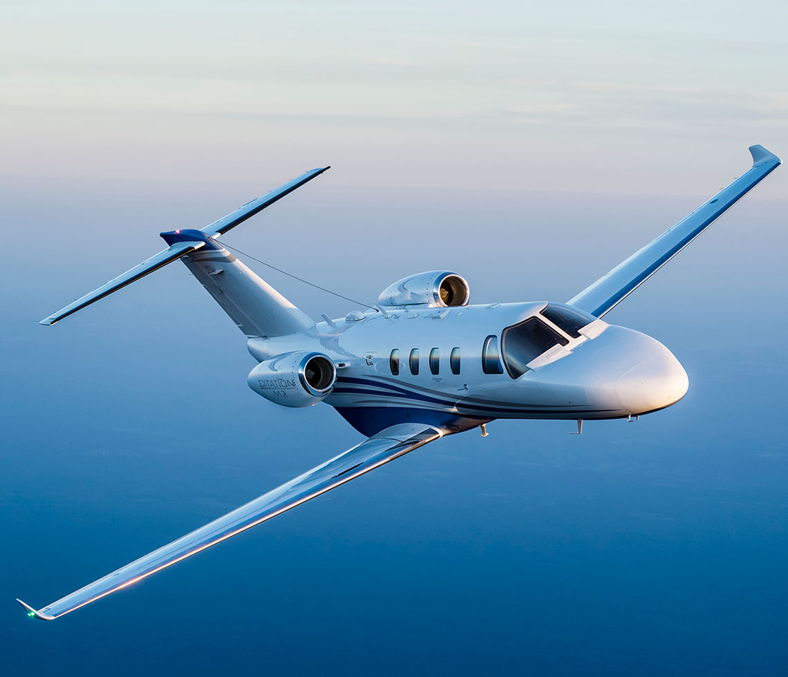 Citation M2 small jet flying in blue sky