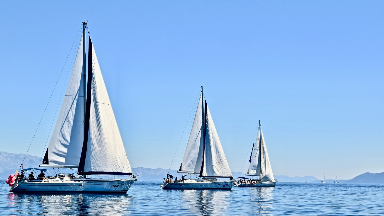 trio of yachts sail the Dalmatian Coast, Croatia.