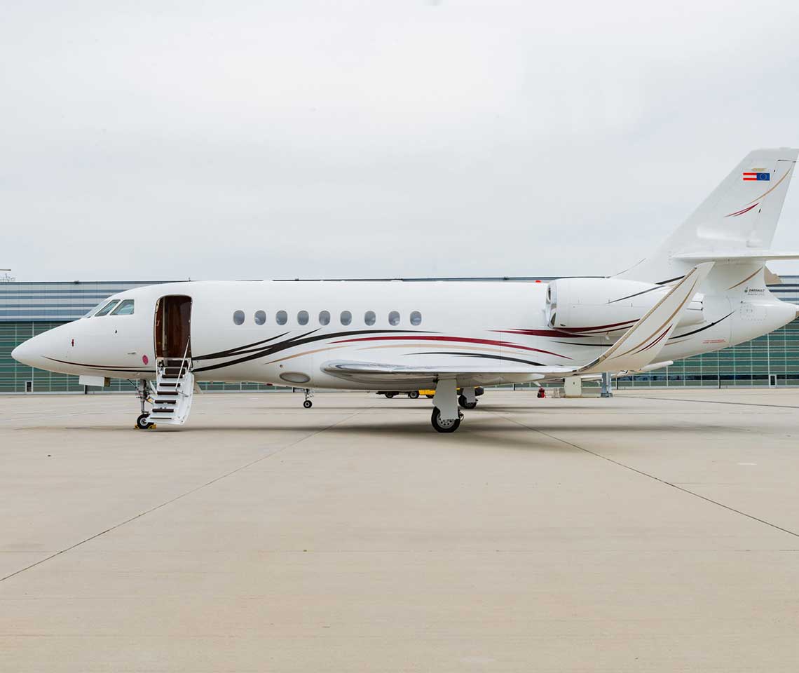 Dassault Falcon 2000 private jet charter parked at FBO runway