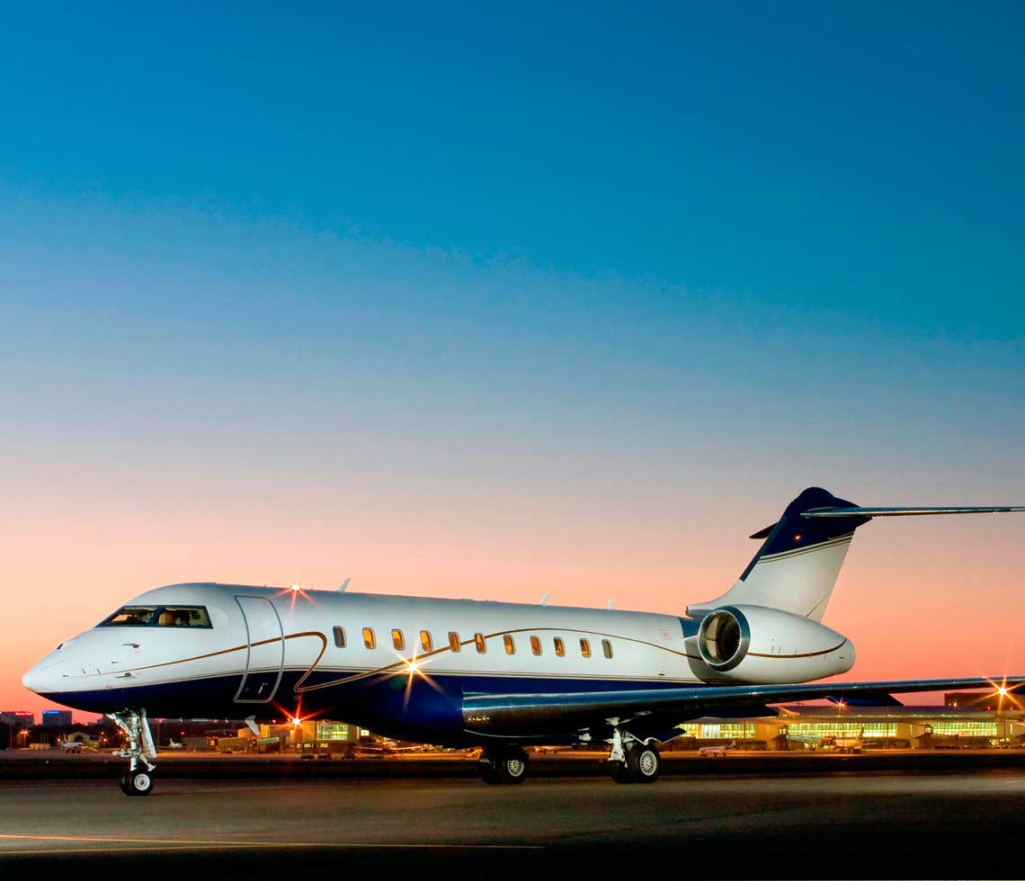 Bombardier Global 5000 private jet charter at airport evening service