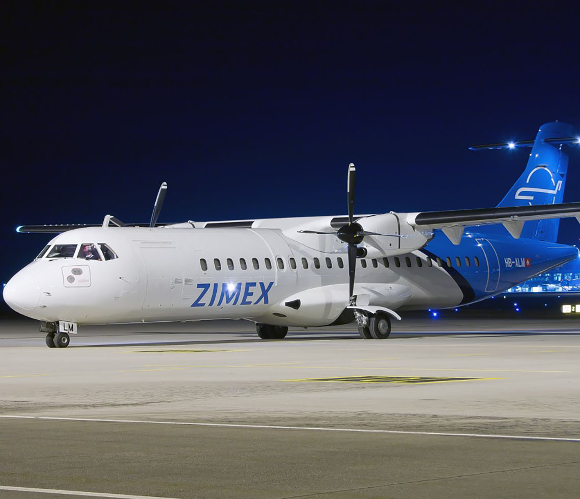 ATR-72 cargo charter plane on airport runway at night