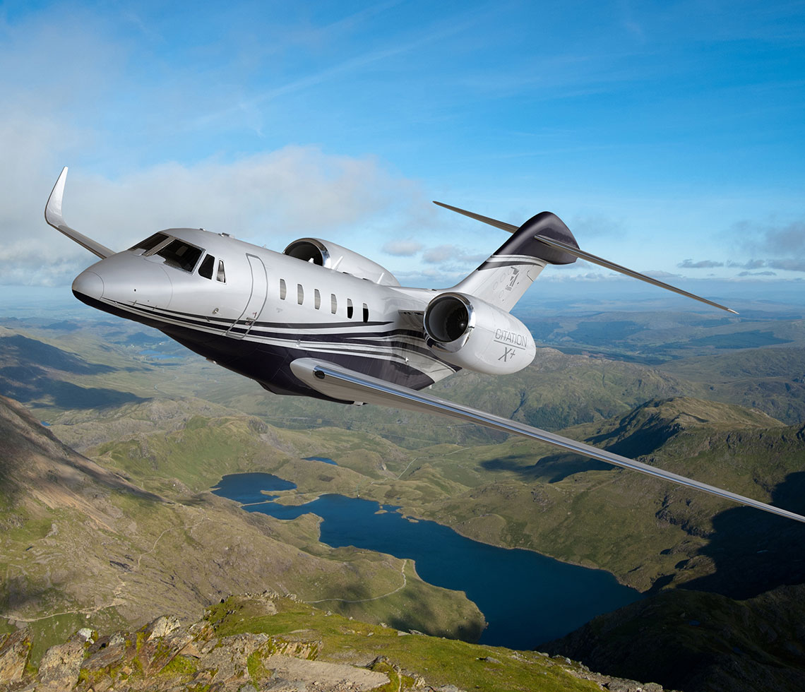 Cessna Citation X private charter mid flight over valley