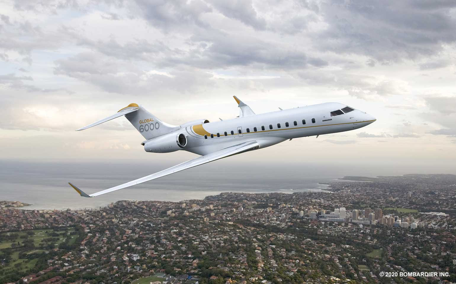 Bombardier Global 6000 private jet chartered flight over coast