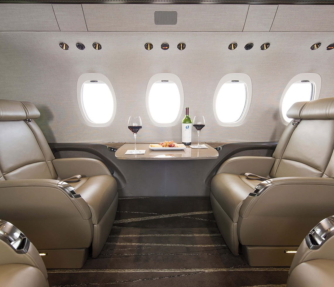 Cessna Citation Latitude private jet interior with wine and glasses