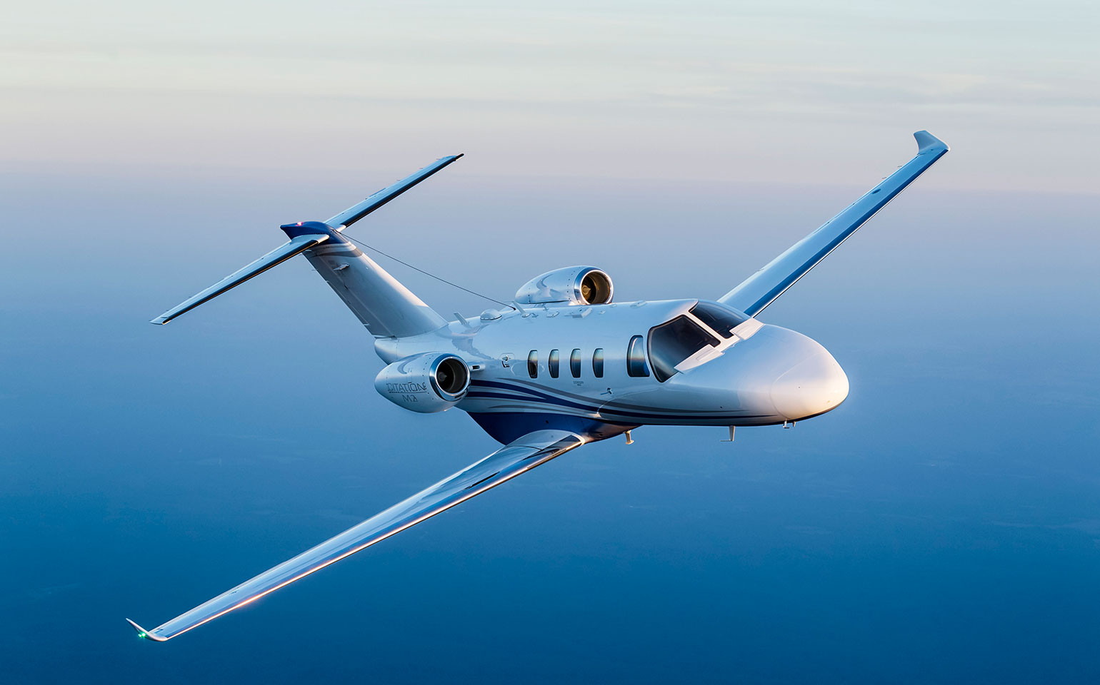 Citation M2 small jet flying in blue sky