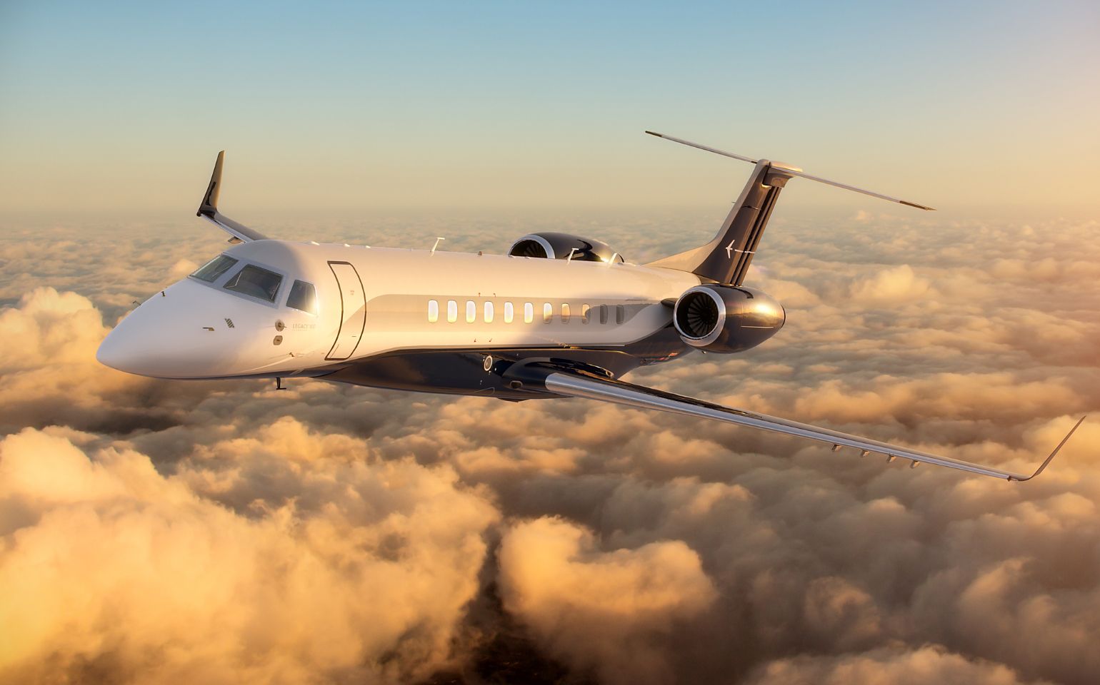 Embraer Legacy 650 private jet charter flying above clouds